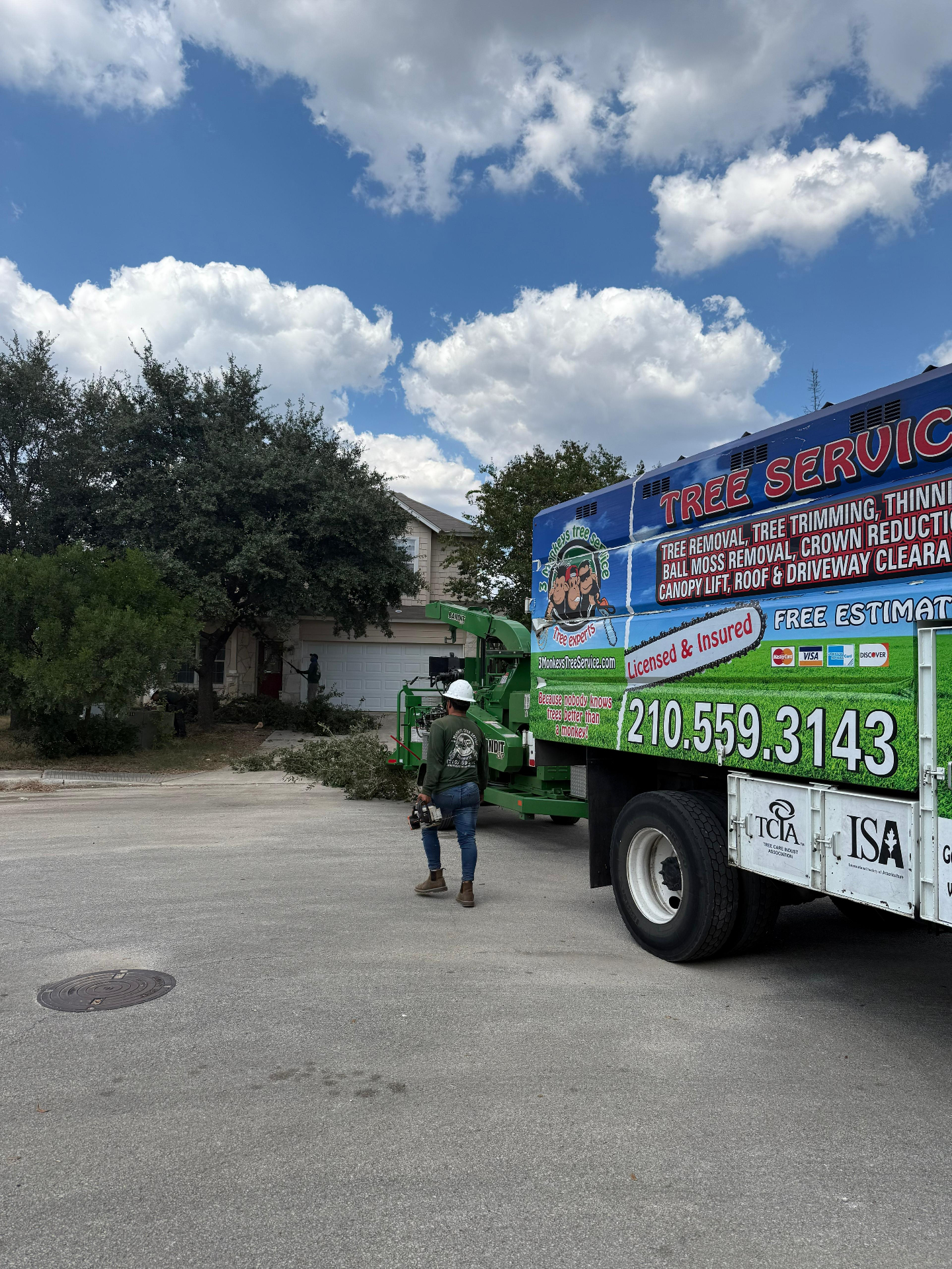 3 Monkeys tree service truck servicing commercial property in San Antonio